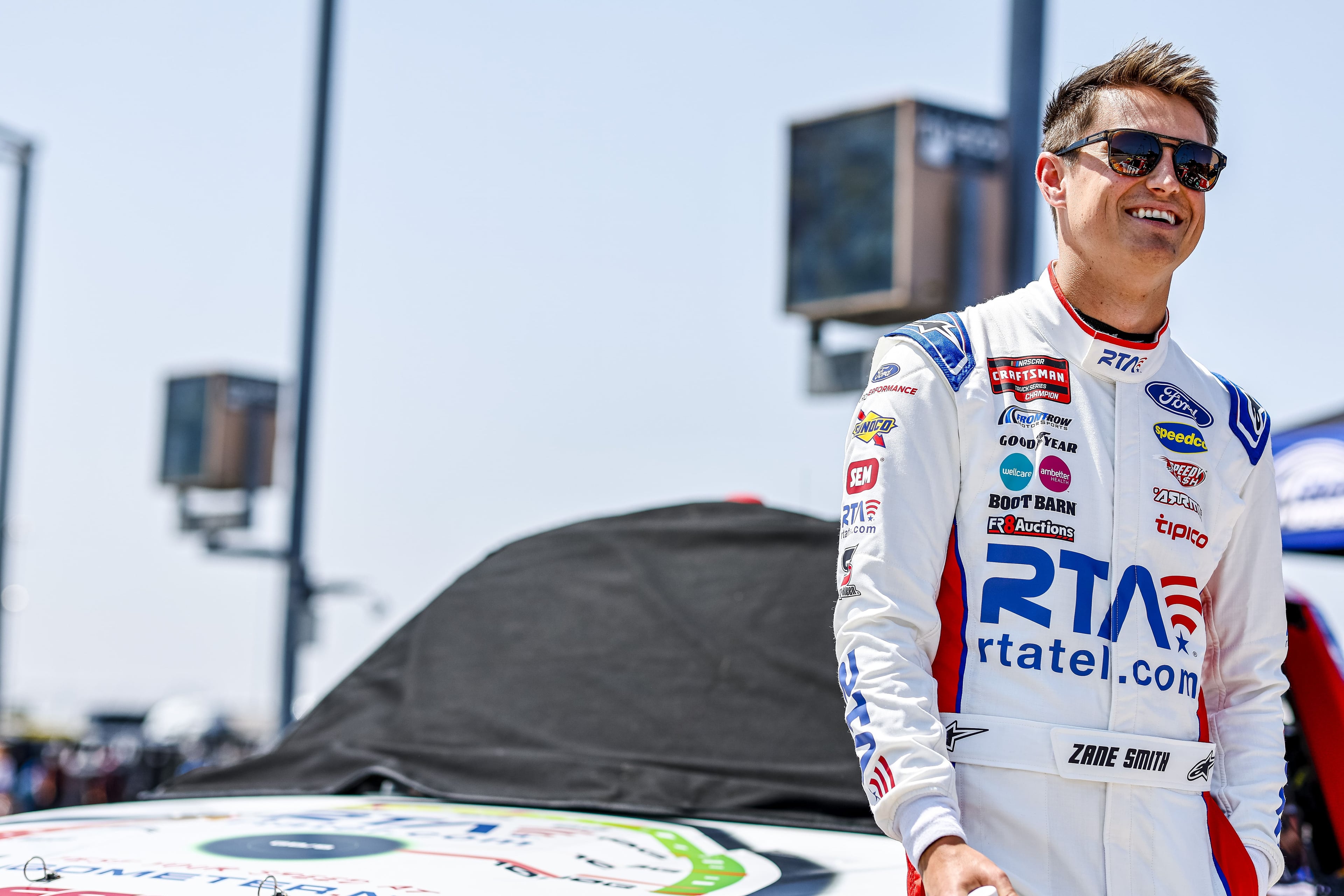 Zane Smith at trackside, RTA rtatel.com prominently displayed on racing suit