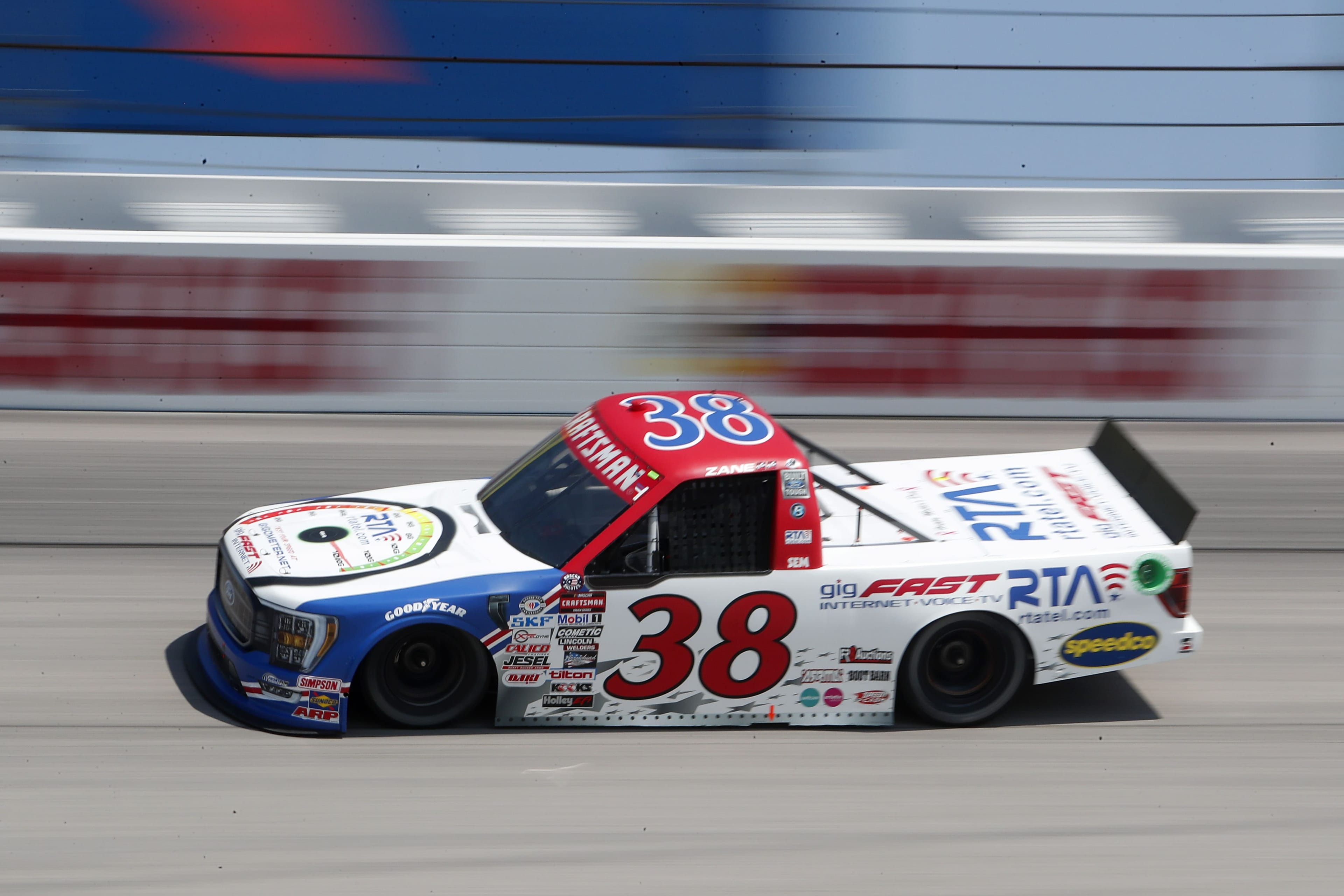 #38 Ford F-150 truck in motion, daytime, gigFAST and RTA logos clearly legible on side