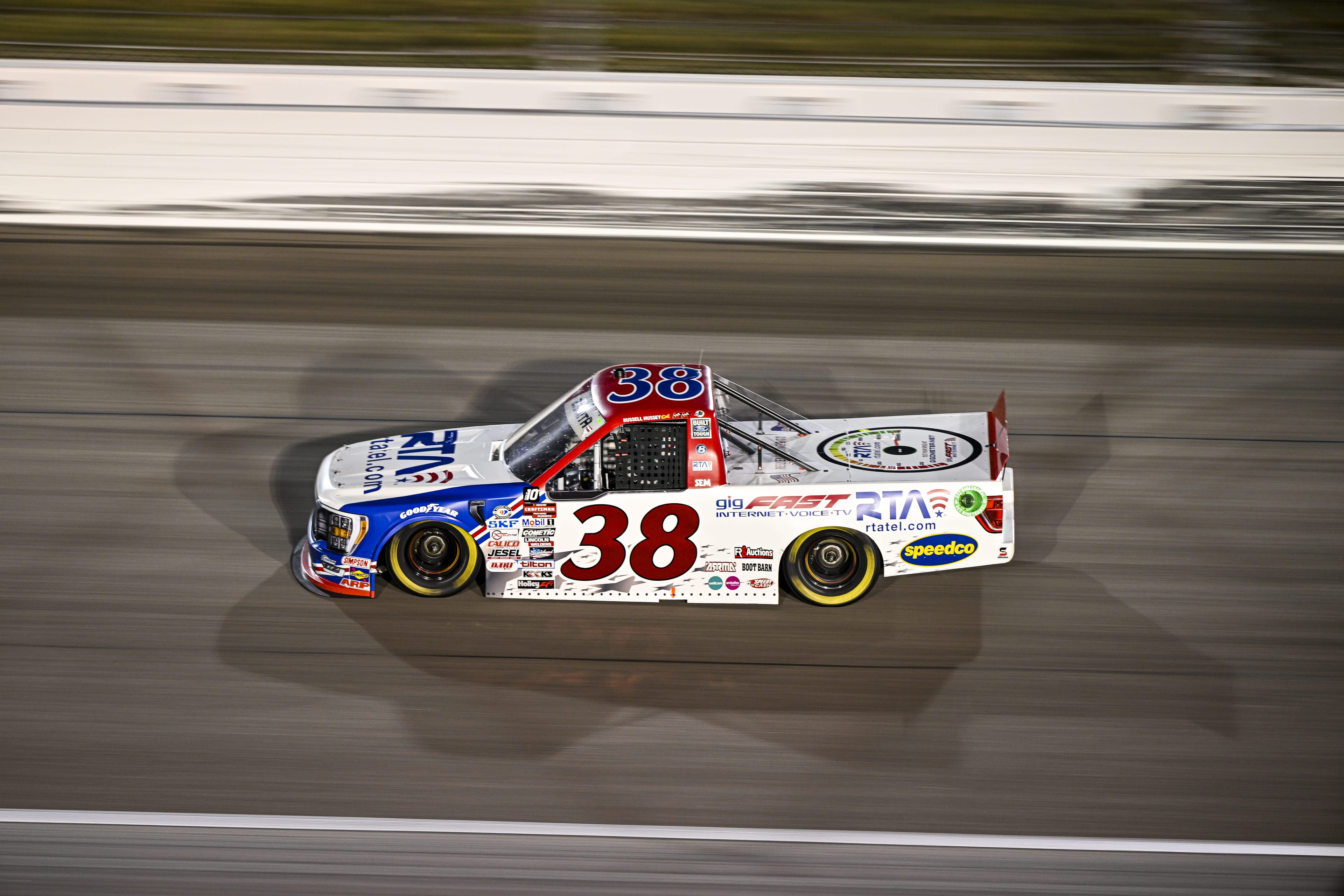 #38 truck viewed from above at night race, dramatic overhead perspective